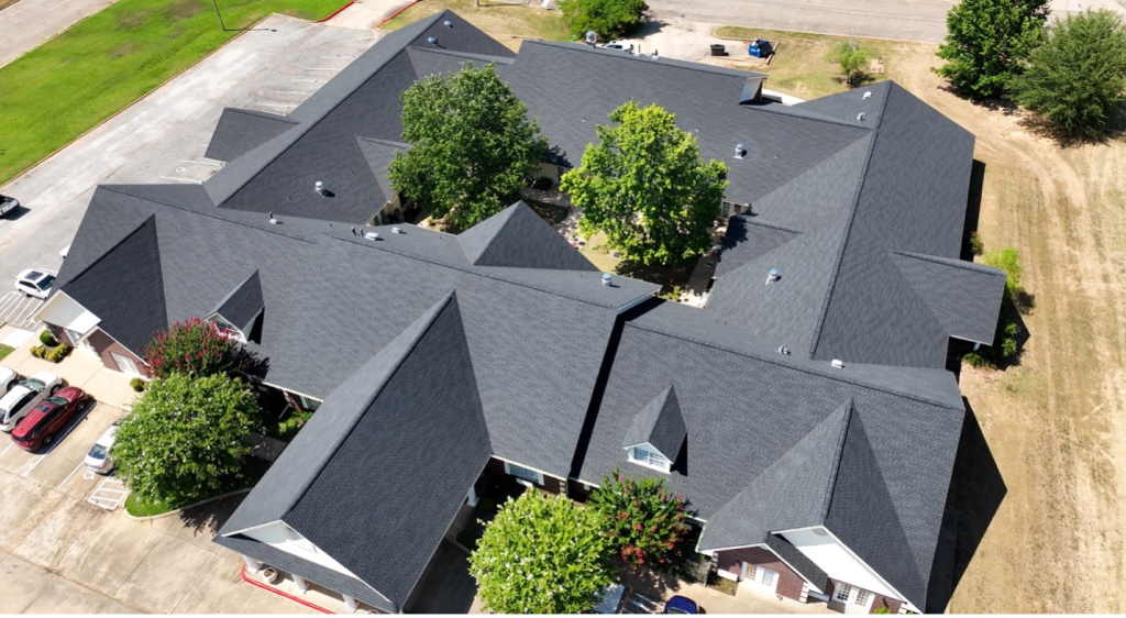 Drone view of asphalt shingle roof on a commercial building